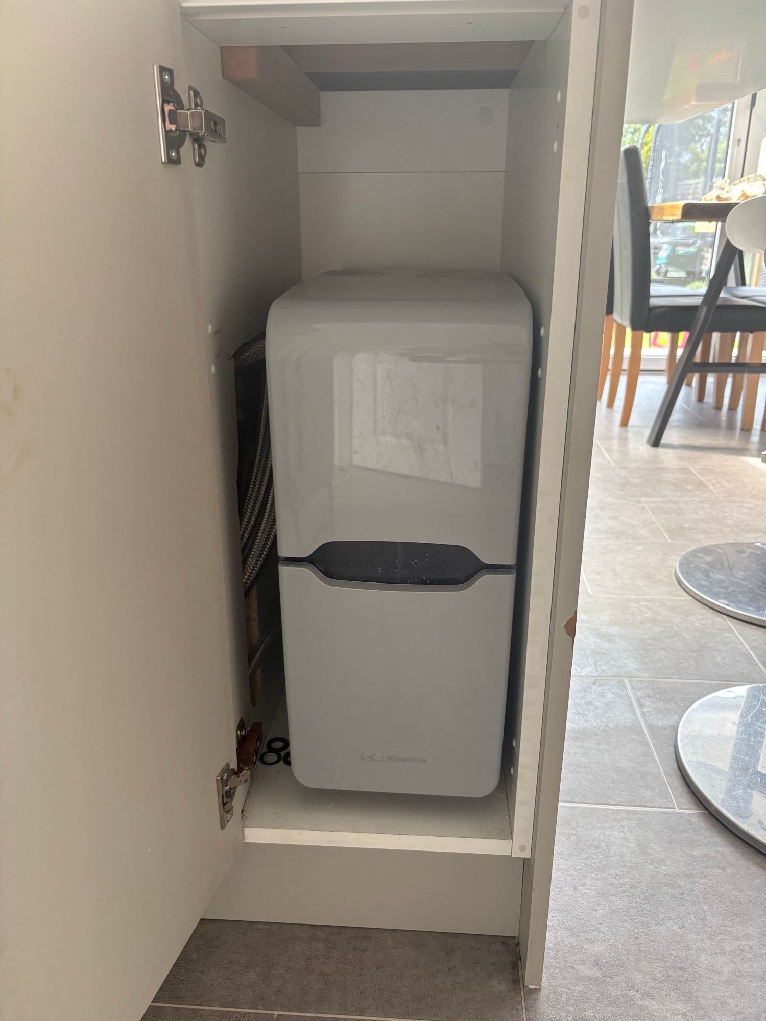 Water softener neatly installed under the kitchen counter